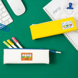 Two officially licensed slim, triangular Miffy pencil cases, featuring one in bright yellow with a white zipper and a "miffy & dan" patch, and the other in cream-colored with a bold blue zipper and a red "miffy" patch.
