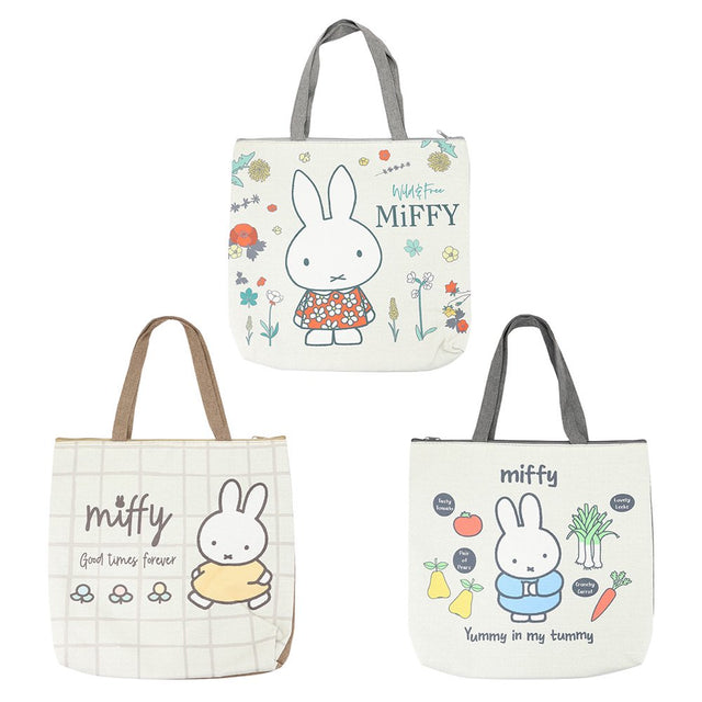Three officially licensed Miffy canvas tote bags with zipper closures. The top bag features Miffy in a floral dress with "Wild & Free" text. The bottom left bag has a grid pattern with Miffy and "Good Times Forever" text. The bottom right bag shows Miffy surrounded by vegetables like carrots and leeks with "Yummy in my Tummy" text.