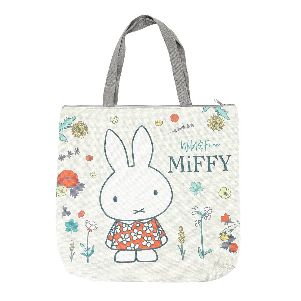 An officially licensed Miffy canvas tote bag with zipper closure, featuring Miffy in a floral dress with "Wild & Free" text.