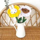 A collection of Miffy Friends Flower Plushies stuffed animals in various colors, each designed to look like a flower with animal faces in the center.