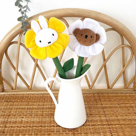 A collection of Miffy Friends Flower Plushies stuffed animals in various colors, each designed to look like a flower with animal faces in the center.