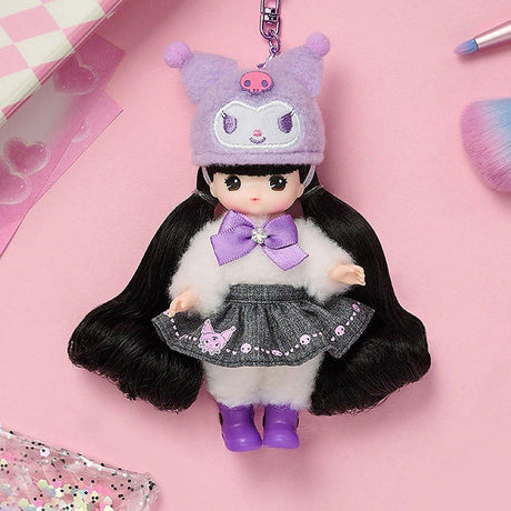 Officially licensed Sanrio and Little Mimi Collaboration Doll Keychain Collection featuring a blonde mini doll wearing a fuzzy lavender purple Kuromi plush hat with a pink skull emblem, a white fuzzy top with a purple satin bow tie, a dark grey denim skirt decorated with Kuromi graphics, and purple boots, attached to a purple metal clasp over a pink background, ideal for adult kidult collectors as a cute aesthetic backpack charm or nostalgic collectible accessory.
