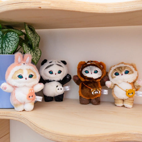 An officially licensed collection of four Mofusand plush cat charms in animal costumes: Pink Bunny, Giant Panda, Red Panda, and Brown Bear displayed on a shelf. Easy to attach to keys, totes, pants or backpacks with a clip-on chain.