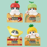 Four Mofusand cat-shaped digital clocks with fruit designs on a light green background