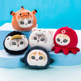 Five officially licensed Mofusand round plush cat keychains wearing sea creature costumes, including a red octopus, dark blue shark, black penguin, orange otter, and white polar bear. Each soft plush charm includes a gold ball chain at the top