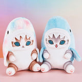 Officially licensed Mofusand plush cats wearing shark costumes. Includes a marble pastel version and a light blue version with a cute open-mouth expression and blue eyes.