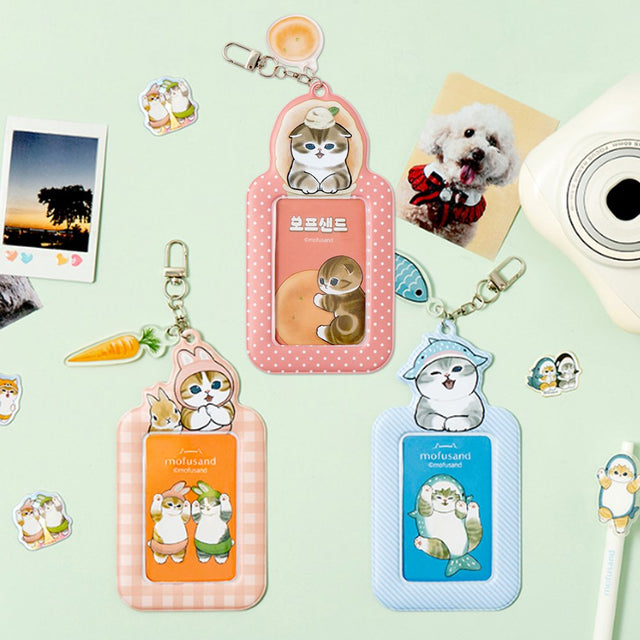 Officially licensed Mofusand collection of three ID card holder keychains featuring cute cat illustrations with matching acrylic charms and secure metal clasps