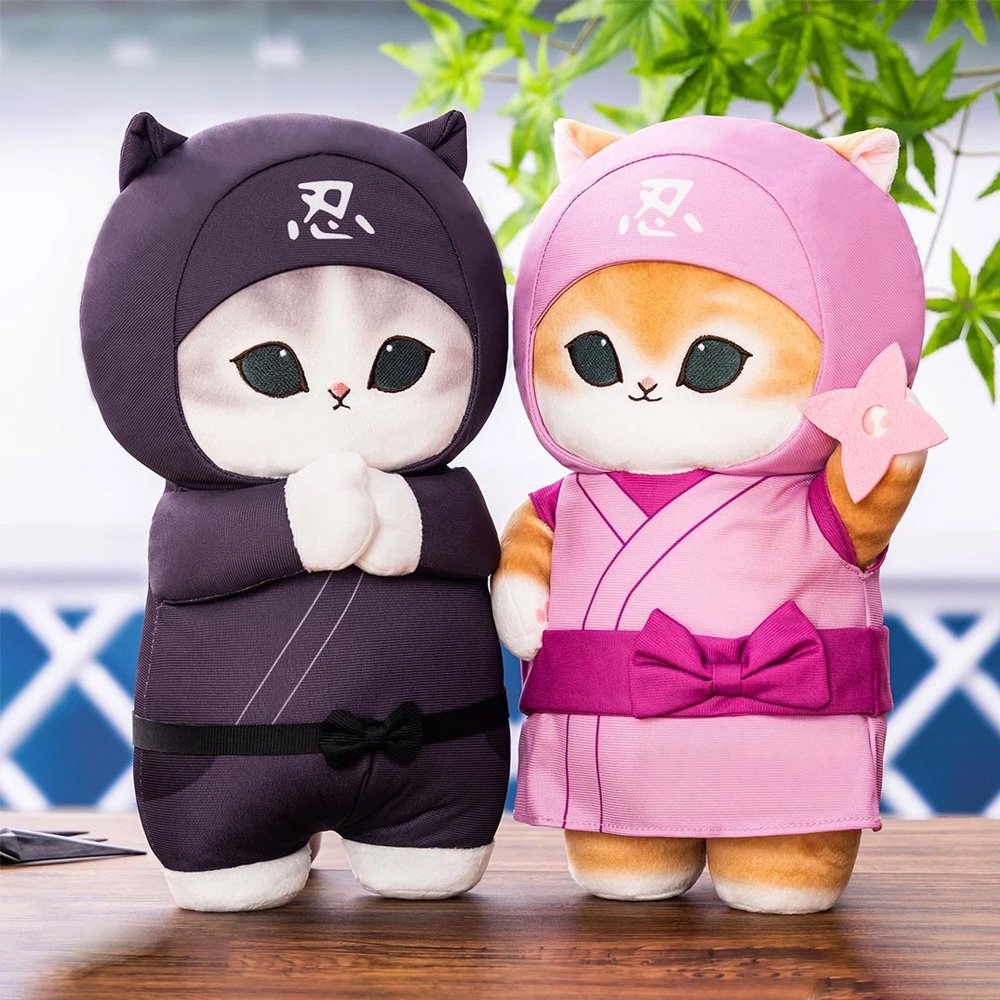 Officially licensed large ginger cat plush in a pink ninja gi and hood, holding a pink plush shuriken star