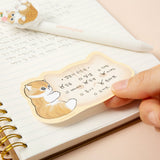 An officially licensed Mofusand die-cut sticky memo pad featuring a brown tabby kitten hugging a cat-shaped writing note