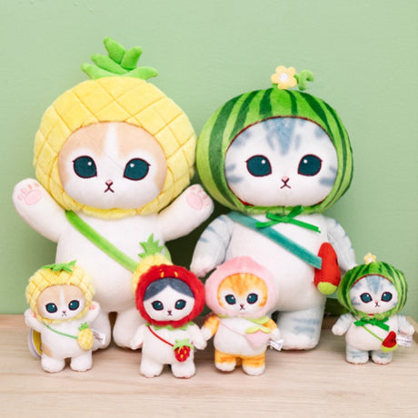 Four officially licensed Mofusand plush cat keychains wearing fruit-themed hoods: red strawberry hood, watermelon hood, pineapple hood, and pink peach hood. Each cat has a matching fruit-shaped crossbody bag and a colored plastic clip.