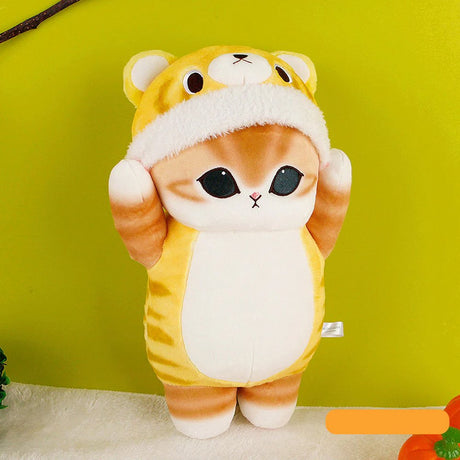 An officially licensed Mofusand plush toy of a brown tabby cat wearing a yellow tiger costume with its paws raised over its head