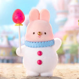 A group of officially licensed Momo Bunny Strawberry Town figures displayed in a miniature outdoor garden setting. The pink bunnies are dressed in various cute outfits, including a snowman suit, a pilot cap, and one sitting inside a strawberry-patterned teacup.