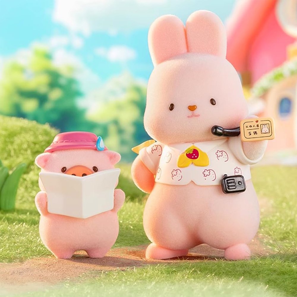 A group of officially licensed Momo Bunny Strawberry Town figures displayed in a miniature outdoor garden setting. The pink bunnies are dressed in various cute outfits, including a snowman suit, a pilot cap, and one sitting inside a strawberry-patterned teacup.