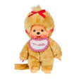 Officially licensed Monchhichi girl plush doll featuring unique golden-beige fur, a long tail, and a cute vinyl face with freckles. The doll has a bright red ribbon tied on its head and wears a white bib with a pink-and-white checkered border that reads "Monchhichi".
