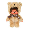 Officially licensed Monchhichi plush doll wearing a fuzzy, light beige teddy bear costume with a hood. The doll features a detailed vinyl face with rosy cheeks and is adorned with a brown ribbon tied around its neck reading "Monchhichi" in white text.
