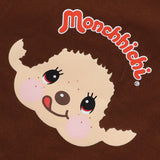 An officially licensed brown Monchhichi apron with red adjustable snap-button neck straps and front utility pockets