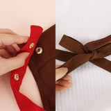 An officially licensed brown Monchhichi apron with red adjustable snap-button neck straps and front utility pockets