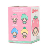 A group of four officially licensed Monchhichi plush keychains dressed in colorful fruit costumes—pink strawberry, yellow lemon, green lime, and blue berry. Each small plush features a metal keychain ring attached to its head.