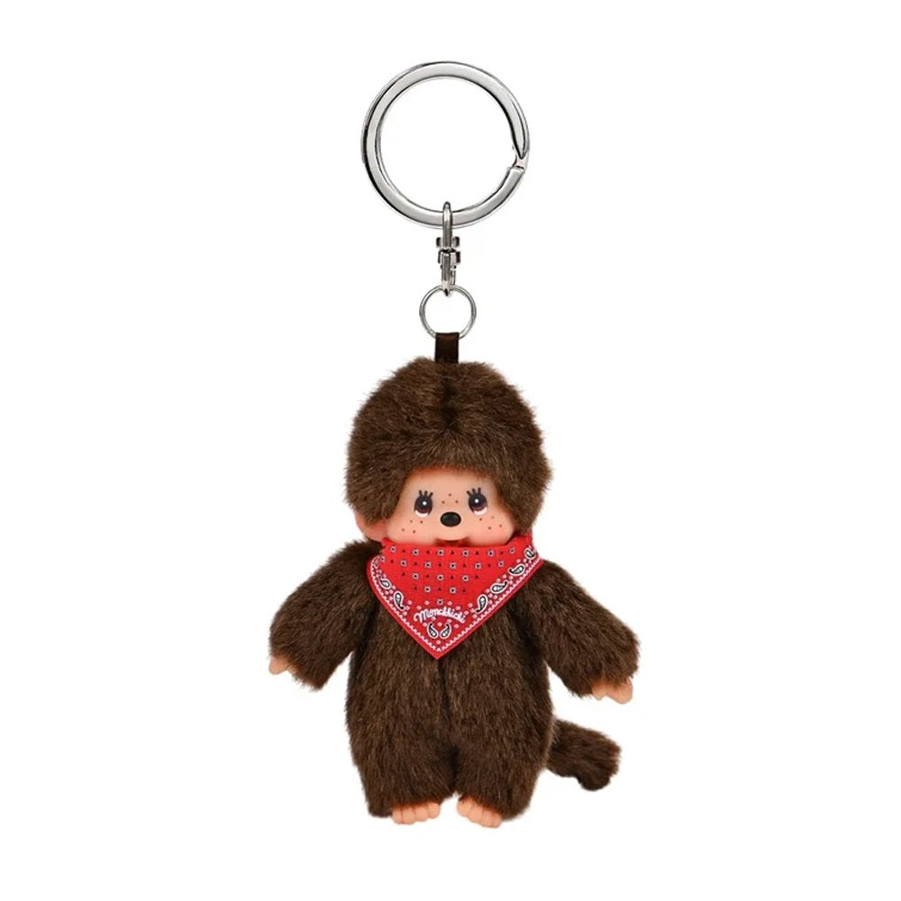 An officially licensed Monchhichi plush keychain wearing a red paisley bandana tied around its neck, attached to a silver metal key ring and clasp