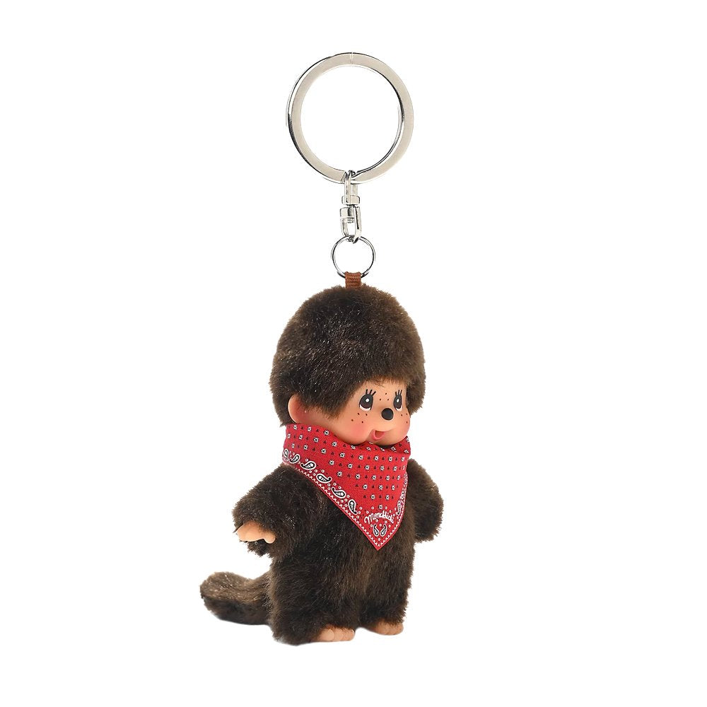 An officially licensed Monchhichi plush keychain wearing a red paisley bandana tied around its neck, attached to a silver metal key ring and clasp