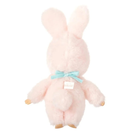 An officially licensed Chimutan bunny plush with fluffy pink fur and long ears, sitting inside a "Monchhichi Friends" decorative box. The plush is wearing a light blue bib with its name printed in red script.