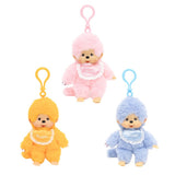 Officially licensed Monchhichi plush keychain doll collection featuring soft pastel color fur and a matching plastic clip attached to its head. Each doll has a freckled vinyl face and wears a shiny satin bib with a white lace border reading "Monchhichi".
