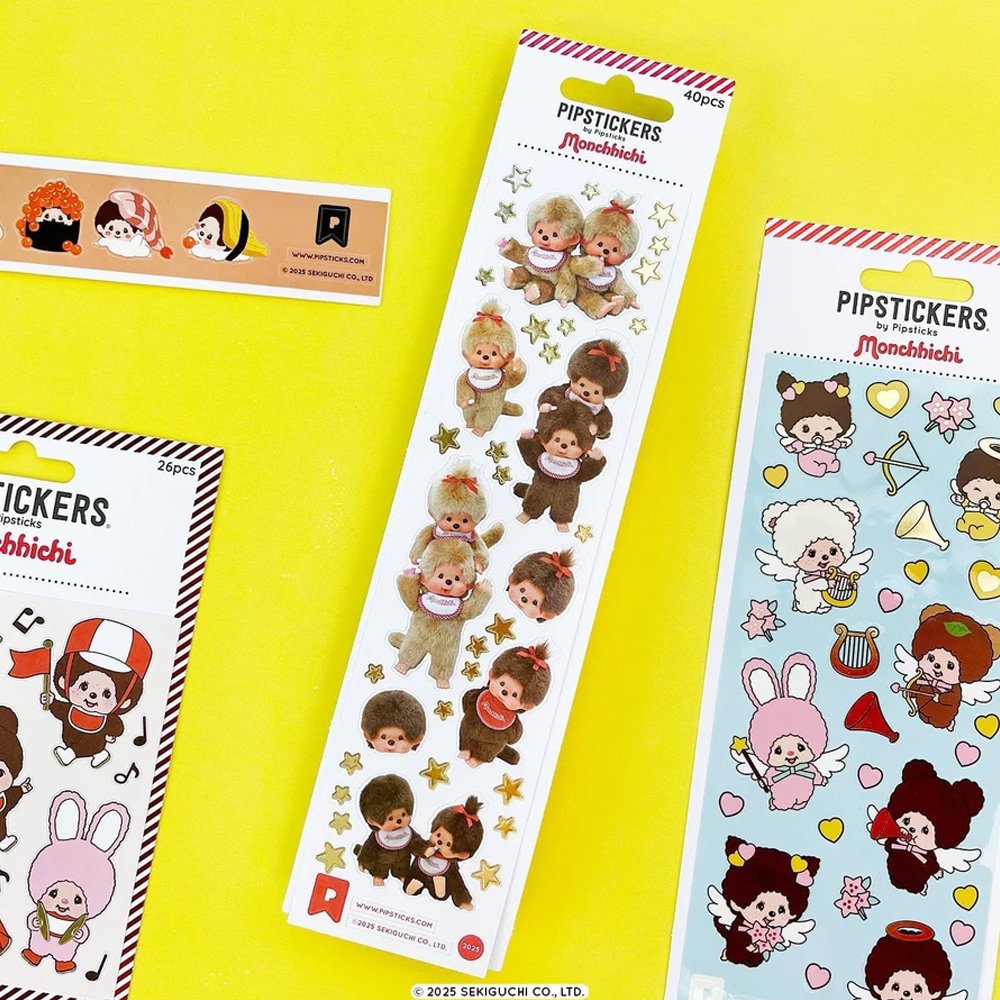 A vertical sheet of officially licensed Monchhichi stickers by Pipsticks, featuring photorealistic illustrations of Monchhichi plush characters and shimmering gold star accents