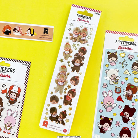 A vertical sheet of officially licensed Monchhichi stickers by Pipsticks, featuring photorealistic illustrations of Monchhichi plush characters and shimmering gold star accents