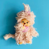  Officially licensed by Sekiguchi Japan, Monchhichi girl dressed in luxurious pink-beige plush fur with her signature thumb-sucking pose. She’s perfect for cuddling, displaying, or gifting to Monchhichi fans of all ages.
