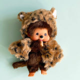 Officially licensed by Sekiguchi Japan, Monchhichi girl dressed in a leopard-print hood complete with cat ears, tail with her signature thumb-sucking pose. she’s perfect for cuddling, displaying, or gifting to Monchhichi fans of all ages.