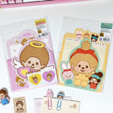 An officially licensed Monchhichi letter writing set displayed with die-cut stationary paper in pink and yellow themes, matching envelopes, and heart sealing stickers