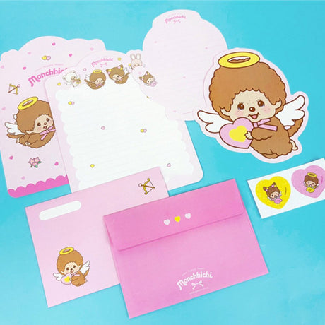 An officially licensed Monchhichi letter writing set displayed with die-cut stationary paper in pink and yellow themes, matching envelopes, and heart sealing stickers