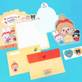 An officially licensed Monchhichi letter writing set displayed with die-cut stationary paper in pink and yellow themes, matching envelopes, and heart sealing stickers