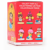 Box of collectible Monchhichi figures with cartoon characters on a red background