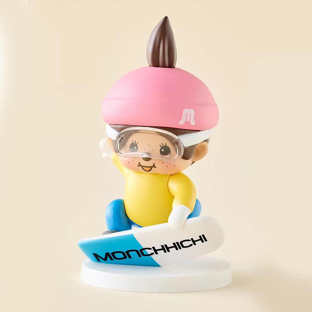 Monchhichi figurine with pink hat and goggles on a beige background