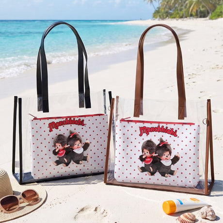 An officially licensed Monchhichi clear tote bag with a removable red polka-dot zippered inner pouch and long shoulder straps, available in black and brown trim