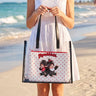 An officially licensed Monchhichi clear tote bag with a removable red polka-dot zippered inner pouch and long shoulder straps, available in black and brown trim