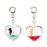 Officially licensed Monchhichi Tsunameez keychain blind box featuring heart-shaped liquid keychain containing a tiny Monchhichi figure and floating glitter stars