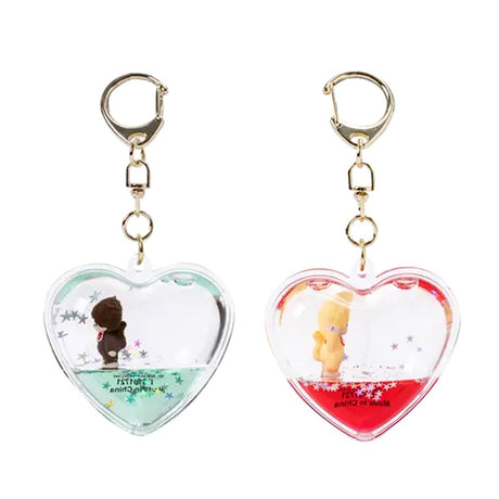 Officially licensed Monchhichi Tsunameez keychain blind box featuring heart-shaped liquid keychain containing a tiny Monchhichi figure and floating glitter stars