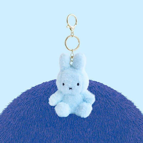 Official Miffy Creamy Mascot Plush Keychains in  baby blue. These fluffy-textured mini miffy dolls feature a durable gold-tone clip, making them perfect aesthetic bag accessories for adult collectors. An ideal nostalgic gift that provides visual rest and minimalist zen for daily use.