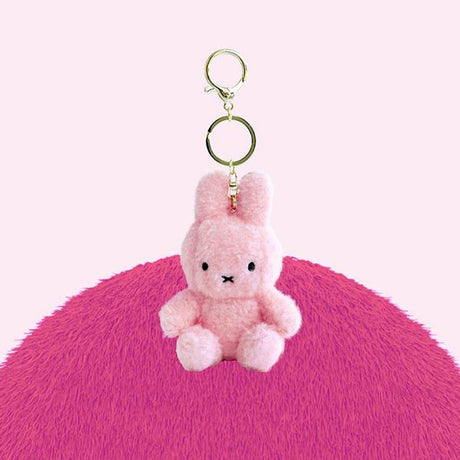 Official Miffy Creamy Mascot Plush Keychains in  pastel pink. These fluffy-textured mini miffy dolls feature a durable gold-tone clip, making them perfect aesthetic bag accessories for adult collectors. An ideal nostalgic gift that provides visual rest and minimalist zen for daily use.