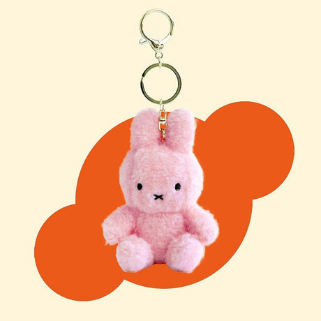 Official Miffy Creamy Mascot Plush Keychains in  pastel pink. These fluffy-textured mini miffy dolls feature a durable gold-tone clip, making them perfect aesthetic bag accessories for adult collectors. An ideal nostalgic gift that provides visual rest and minimalist zen for daily use.