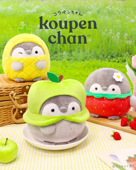 Officially licensed Spiralcute Koupen Chan fruit series plush collection showcasing three round penguin characters dressed in pineapple, green apple, and strawberry costumes on a picnic blanket, perfect for kawaii desk decor and emotional comfort toy gifting.