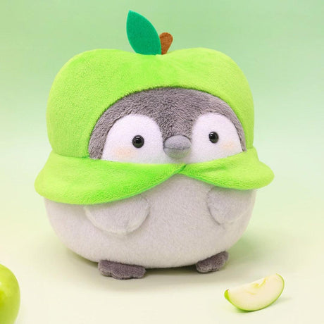 Soothing Koupen Chan "Positive Penguin" for emotional support and anxiety relief. This soft green apple plush acts as a tactile healing tool for adult self-care and mindfulness.