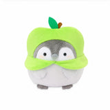 Officially licensed Spiralcute Koupen Chan green apple costume plush toy featuring a cute round grey penguin with rosy cheeks, soft fleece texture, and a felt leaf stem on its head, serving as a comforting desktop healing companion for adult and kidult collectors.
