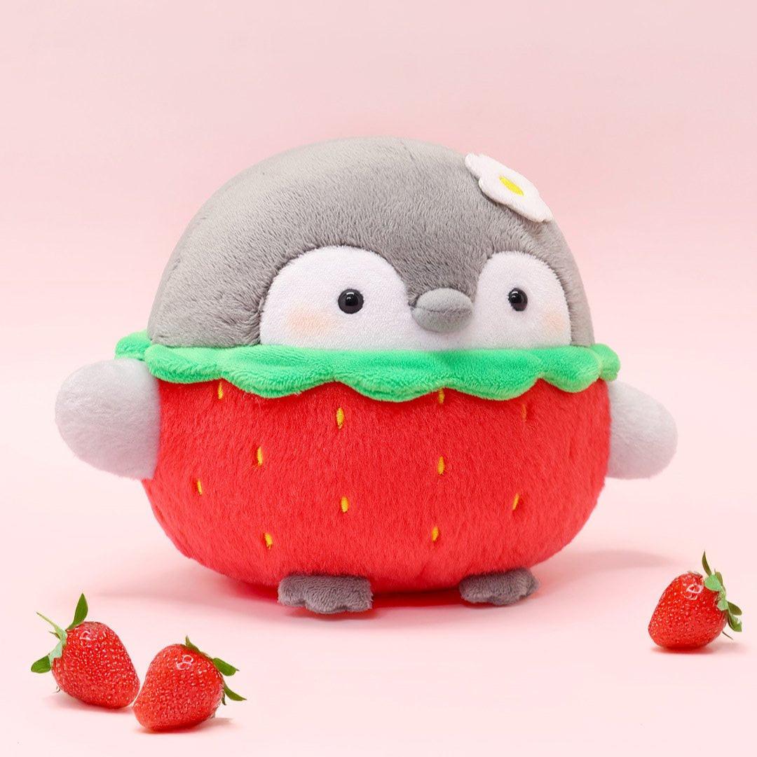 Officially licensed Spiralcute Koupen Chan strawberry costume plush toy showcasing a round grey penguin with a small white flower on its head, fluffy strawberry shaped body with yellow seed embroidery, and open arms, designed as an emotional support plushie for adult & kidult desk decoration.