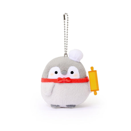 Official Spiralcute Koupen Chan Baker Costume Plush Mascot Keychain featuring a soft grey penguin wearing a white chef hat and red bow tie while holding a yellow wooden rolling pin, attached to a sturdy silver ball chain for bags and backpacks to serve as a comforting workplace healing companion and emotional support tool for adult kidult collectors.