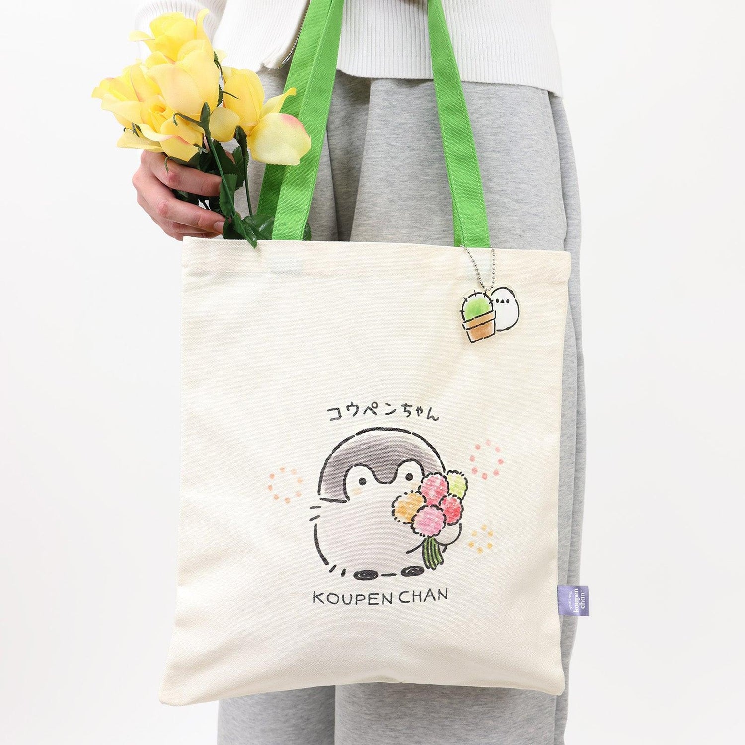 Official Spiralcute Koupen Chan Canvas Tote Bag featuring a cute flower bouquet illustration. Decorated with a matching acrylic keychain, this aesthetic tote is ideal for spring outings, casual picnics, and cottage-core or k-fashion inspired outfits. 