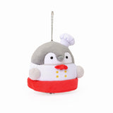 Officially licensed Spiralcute Koupen Chan Bakery Series plush mascot keychain featuring the cute grey penguin wearing a white patissier uniform with yellow buttons, a red bow tie, a red apron, and a tilited white baker hat, with a silver ball chain, made of soft fuzzy material for adult kidult collectors as a kawaii aesthetic bag accessory or collectible plush charm.