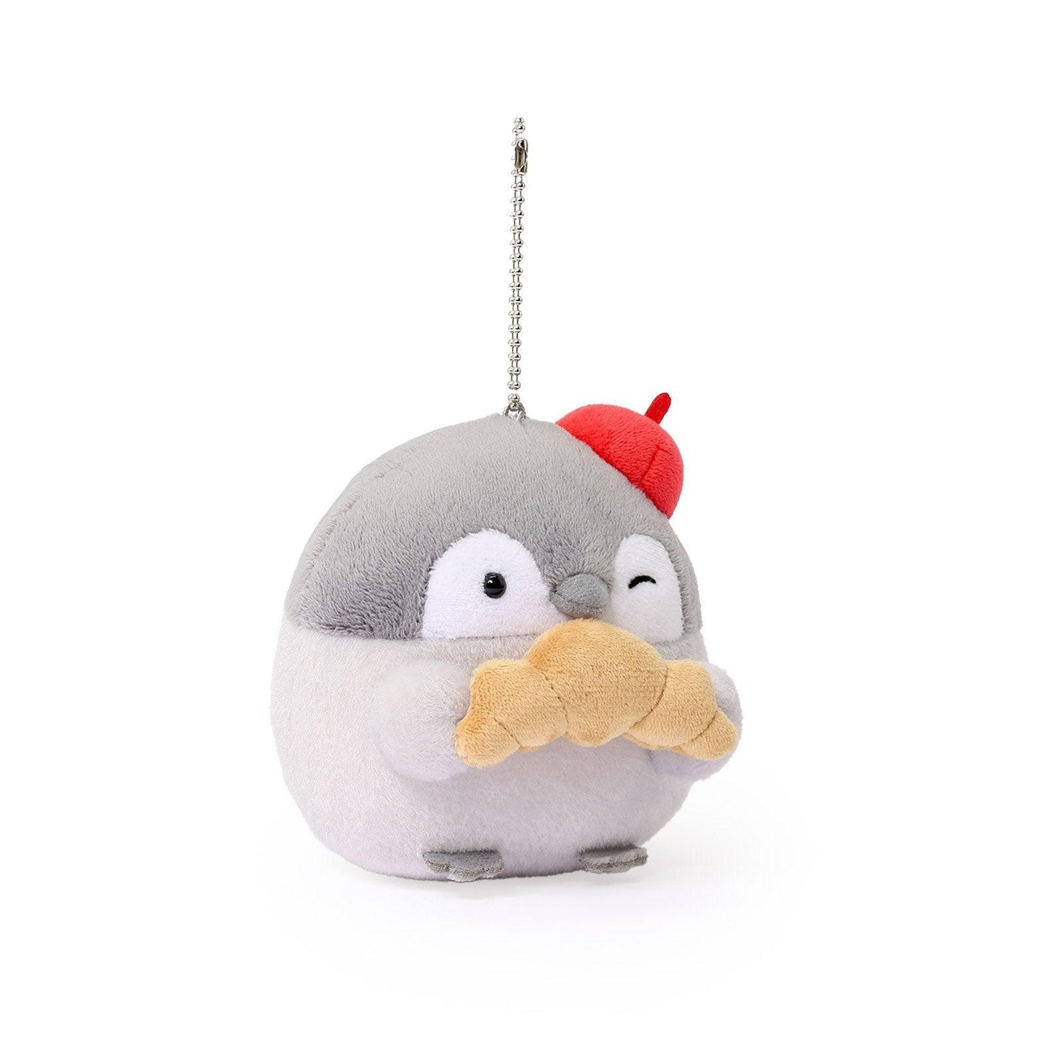 Officially licensed Spiralcute Koupen Chan Bakery Series plush mascot keychain featuring the cute grey penguin wearing a bright red artist beret hat and holding a croissant, with a silver ball chain, made of soft fuzzy material for adult kidult collectors as a kawaii aesthetic bag accessory or collectible plush charm.